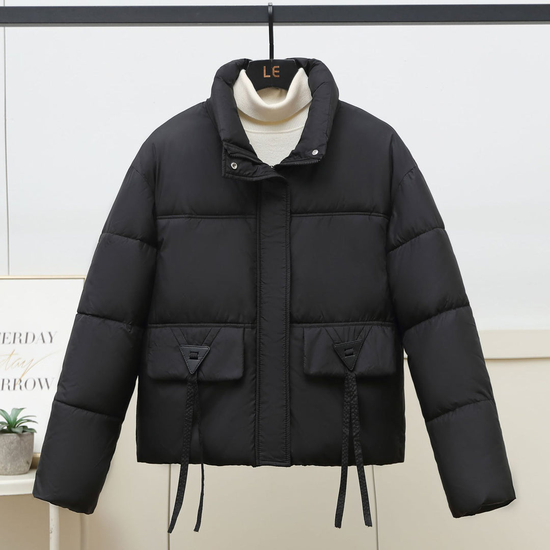 Quilted transitional jacket for women with high collar and practical modern pockets Lune London