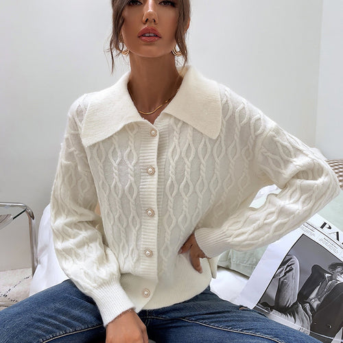 Ladies chunky sweater with an elegant cable knit pattern and chic pearl buttons