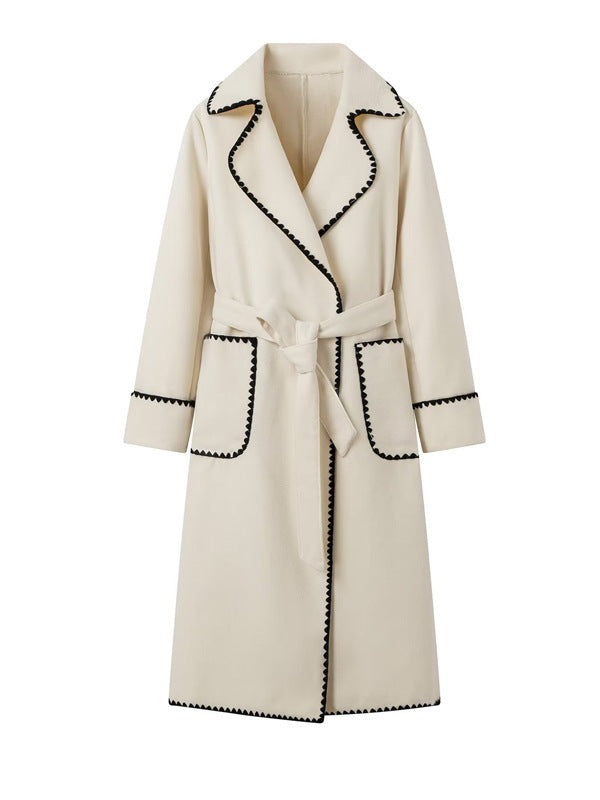 Elegant long coat for women with a tie belt and contrasting piping Lune London