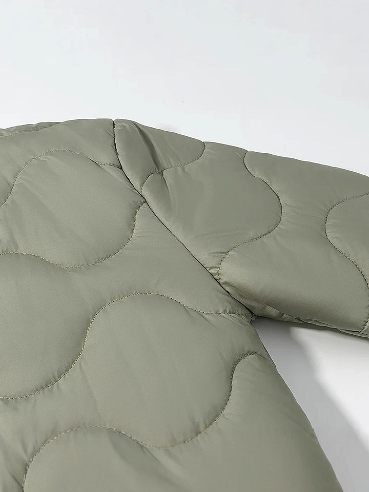 Quilted transition jacket for women with a soft fabric texture and practical snap buttons Lune London