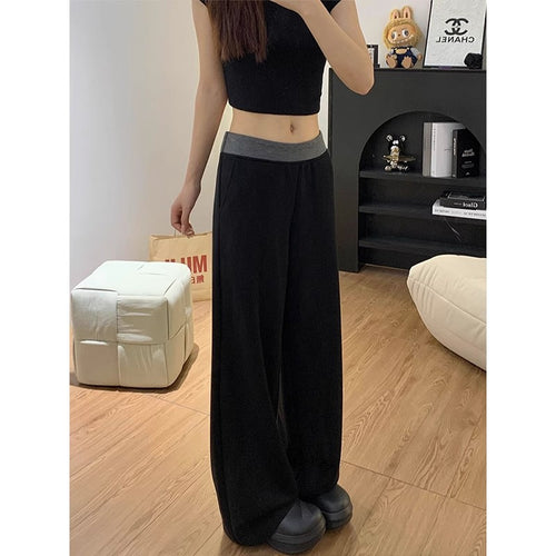 Women's casual fabric trousers with a wide cut and elastic waistband