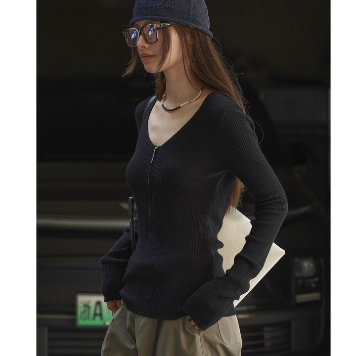 Women's fitted ribbed top with visible zipper at the back