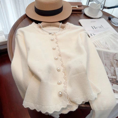 Knitted jacket for women with decorative pearl buttons and a delicate ribbed structure Amarae