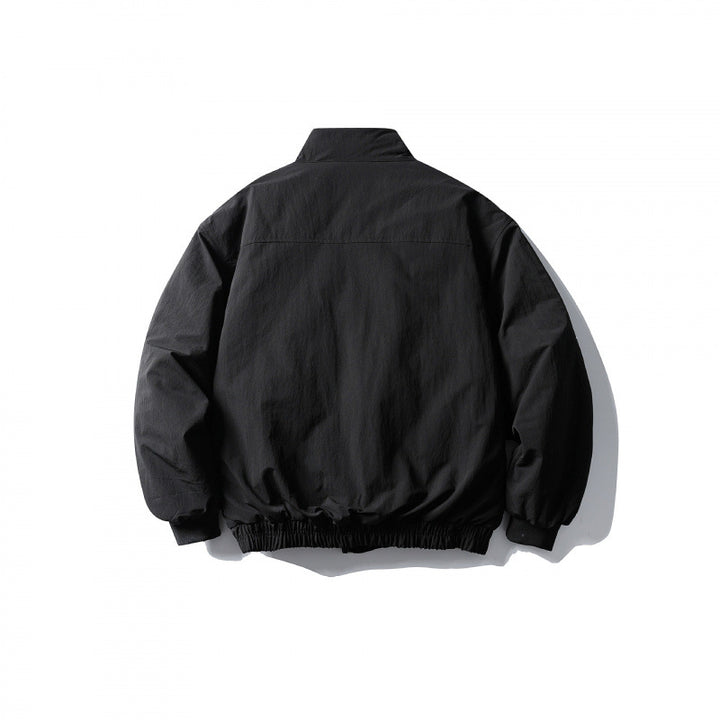 Unisex short boxy isolation jacket with diagonal flap pocket detail and elastic hem Amarae
