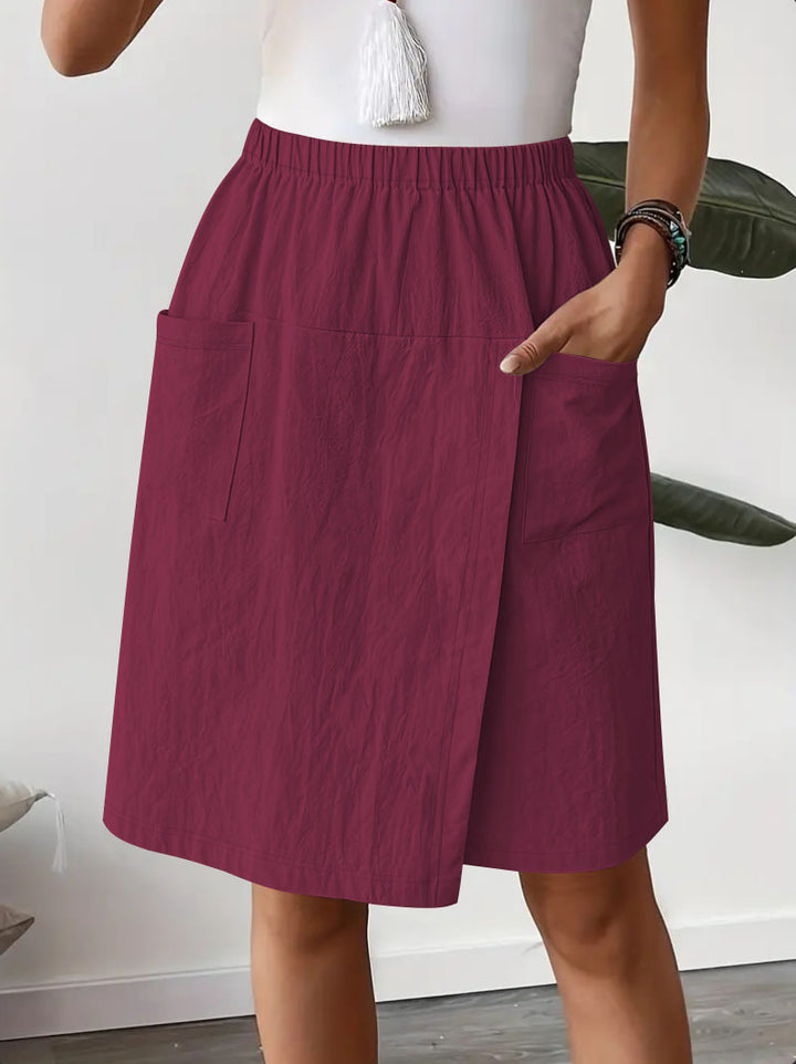 Mid-length wrap skirt for women with elastic waist and practical pockets Lune London