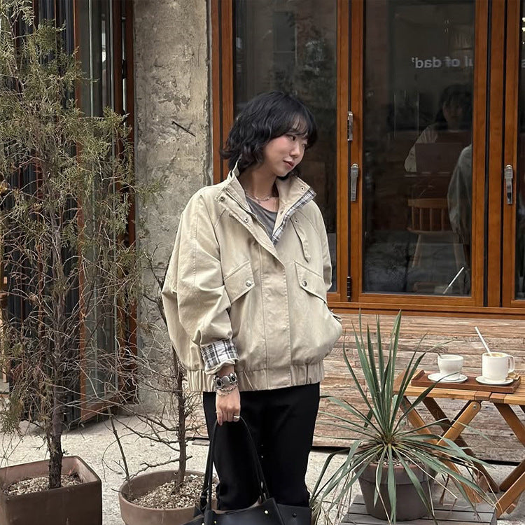 Women’s short bomber jacket with stand-up collar, chin strap, and checkered sleeve lining Amarae