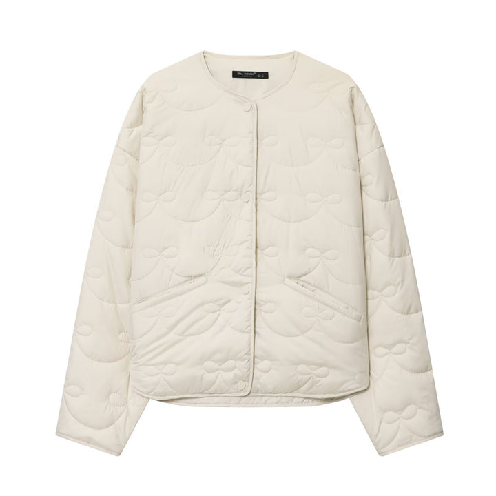 Women's short cut quilted jacket with round neckline and tonal bow quilting Amarae