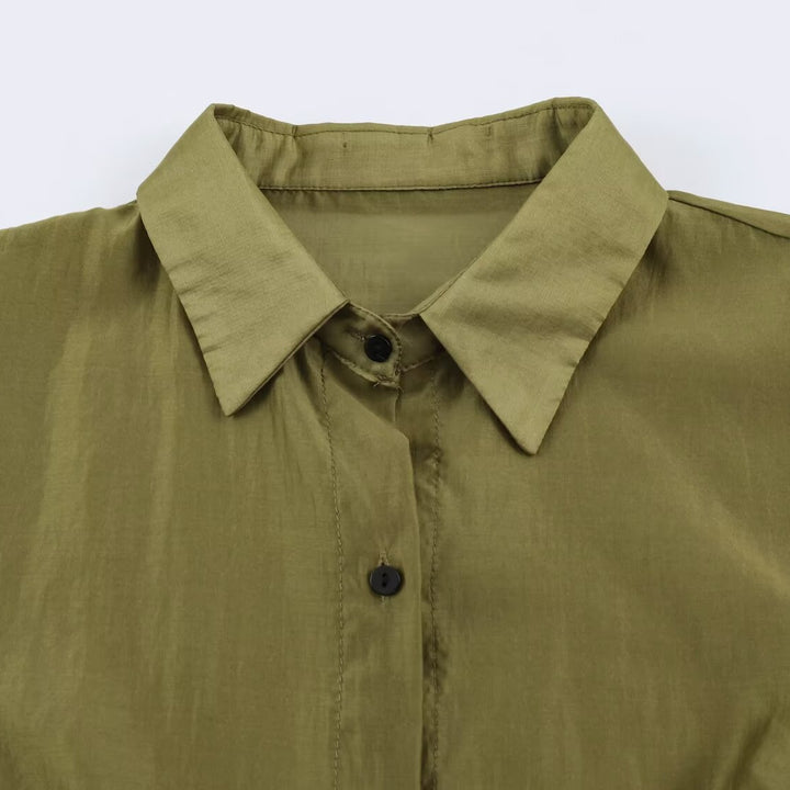 Women's silk effect blouse with voluminous sleeves, layered ruffles, and smocked cuffs