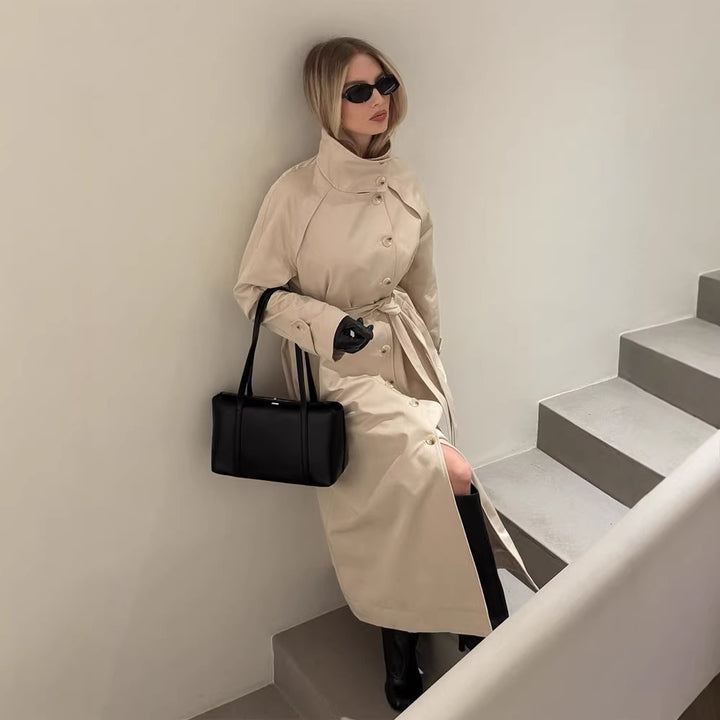 Ladies maxilength trench coat with high stand-up collar, double-breasted button placket and tie belt Amarae