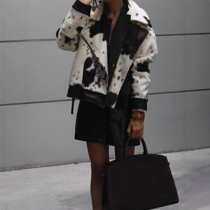 Women short padded biker jacket made of faux fur in cow print with contrast leather trim Amarae