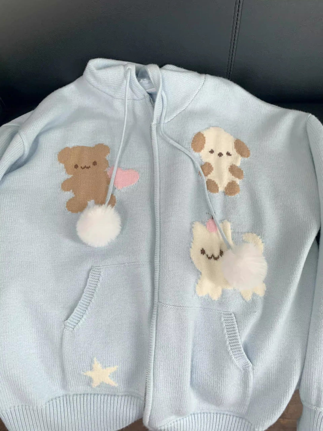 Hooded jacket for ladies with playful animal patterns and pom poms Lune London