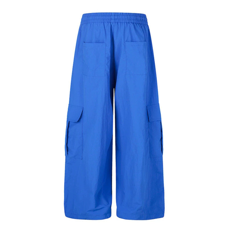 Women's wide palazzo cargo pants with elastic drawstring waistband, large flap pockets, and statement writing print Amarae