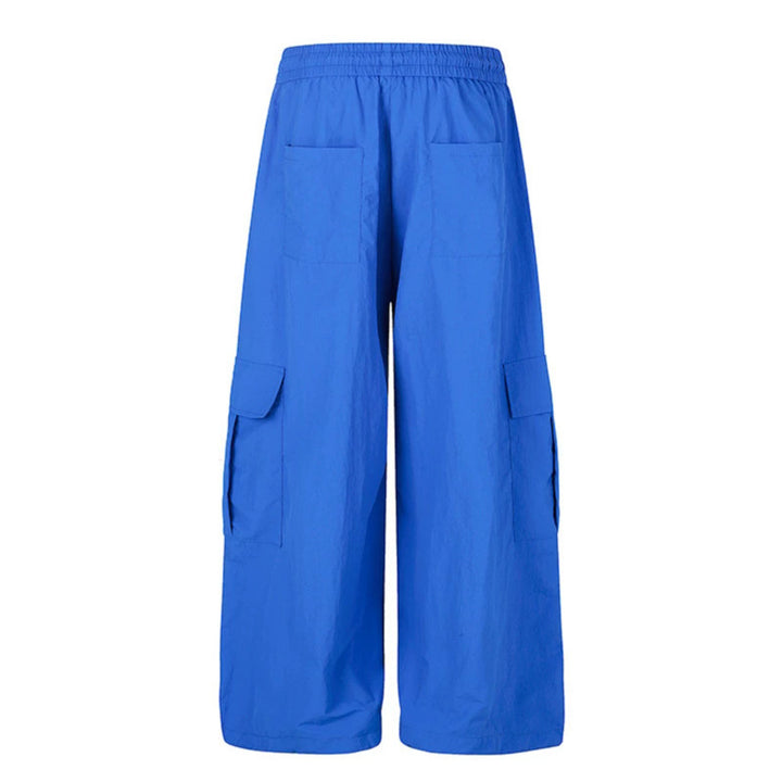 Women's wide palazzo cargo pants with elastic drawstring waistband, large flap pockets, and statement writing print Amarae