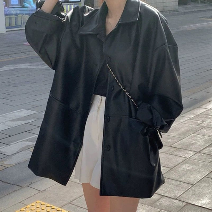 Women's fashionable leather jacket in oversized style with classic collar and decorative buttons Chic & Stil