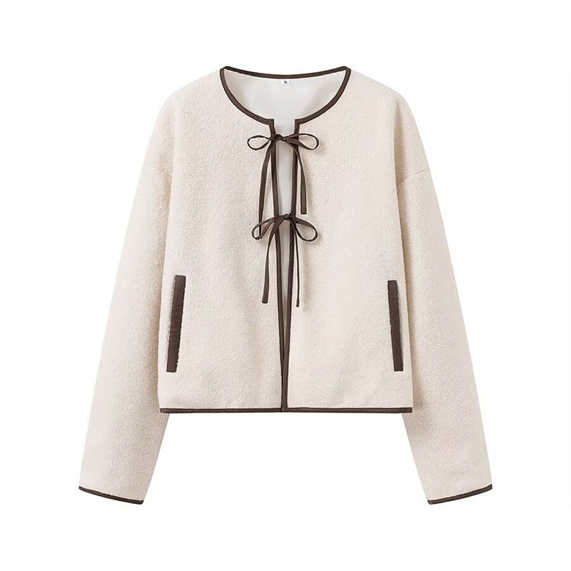 Fashion women's transitional jacket with decorative drawstring and side pockets.