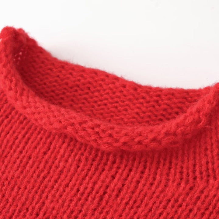 Women’s chunky knit oversized pullover with short stand-up collar and decorative knot detail