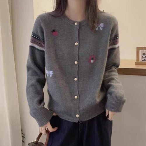 Knitted jacket for women with elegant appliqués and chic and stylish button details