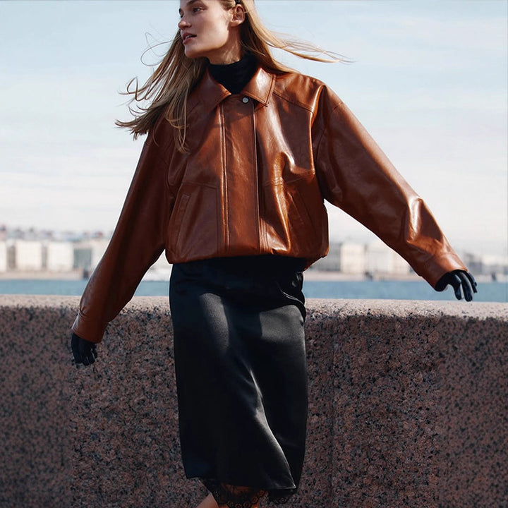 Women's short blazer made of vegan smooth leather with boxy silhouette and concealed snap button placket Amarae