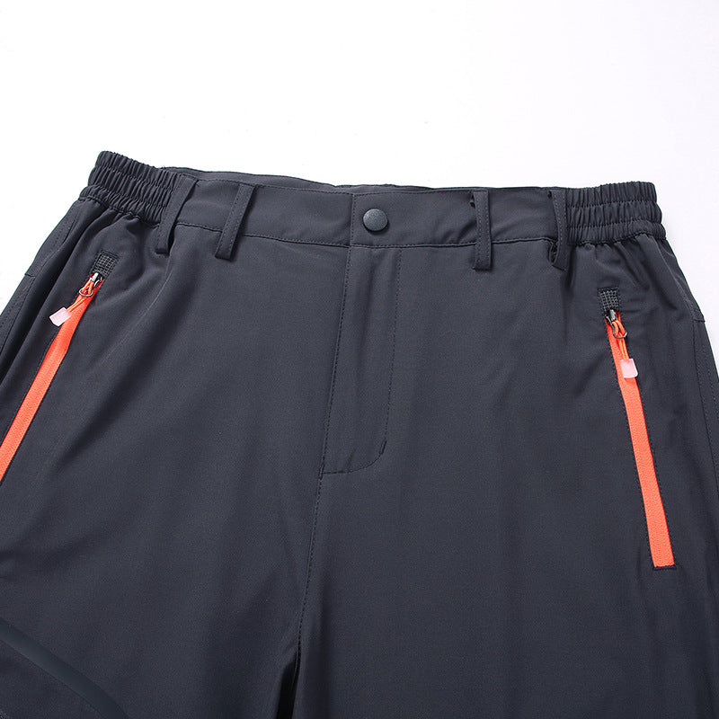 Men's softshell outdoor pants with reinforced knee sections, zippered pockets, and elastic waistband Amarae