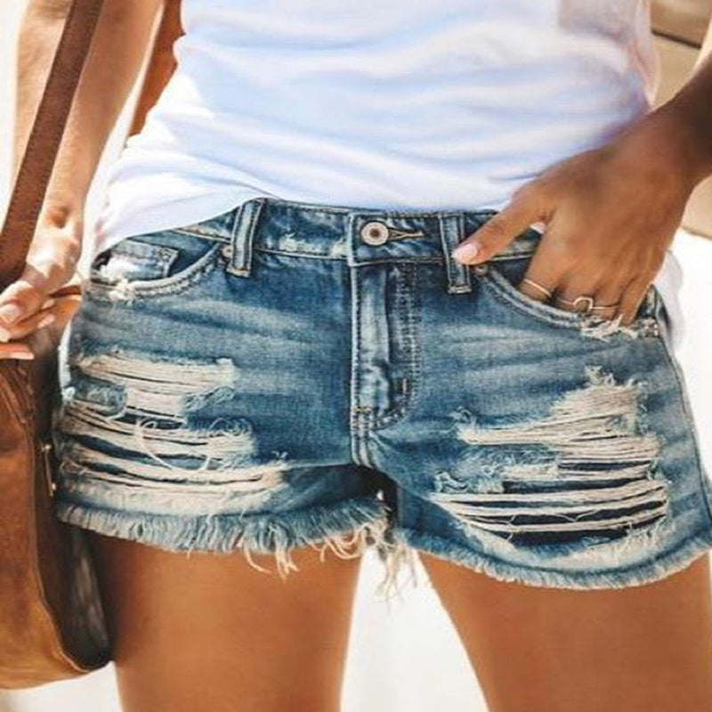 Ladies trendy destroyed denim shorts with frayed hems and fashionable ripped details Lune London