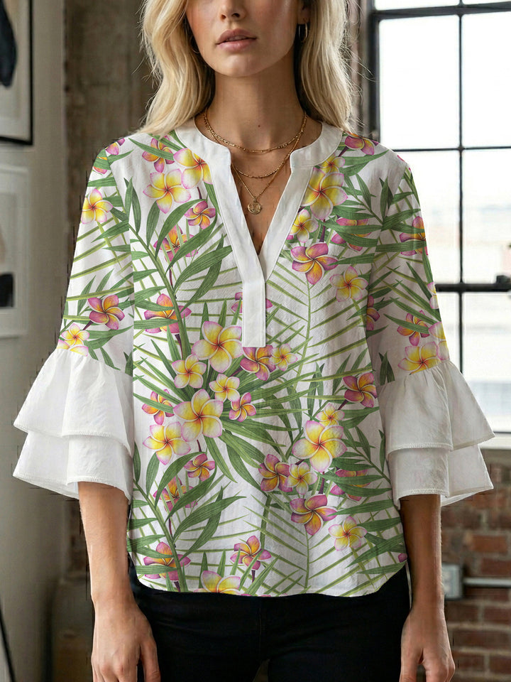 Women’s blouse with voluminous ruffled sleeves and floral pattern Lune London