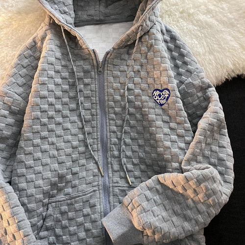 Women's hoodie jacket made of structured material with practical pockets and fashionable design