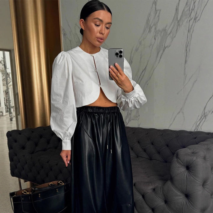 Women short-cut blouse with curved hem edge and voluminous puff sleeves Amarae