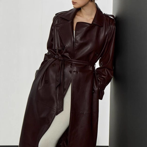 Elegant trench coat in faux leather for women with belt and chic fashion details