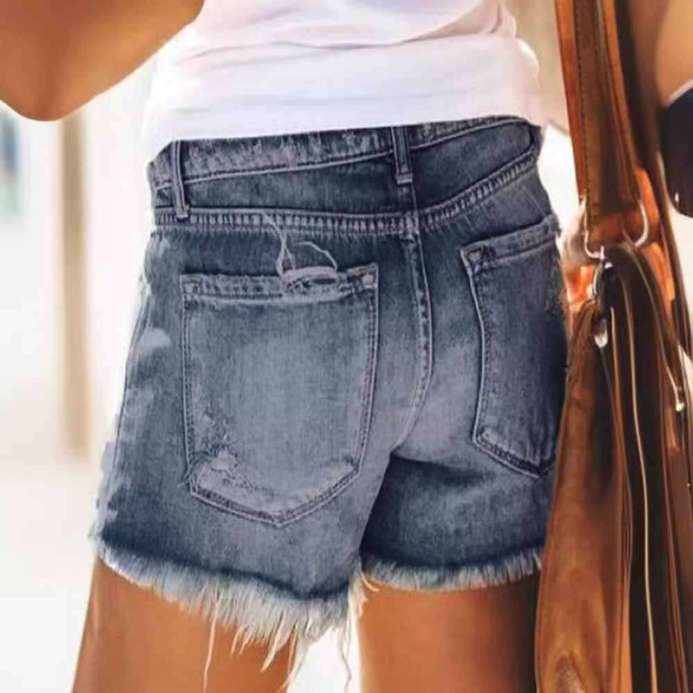 Ladies trendy destroyed denim shorts with frayed hems and fashionable ripped details Lune London