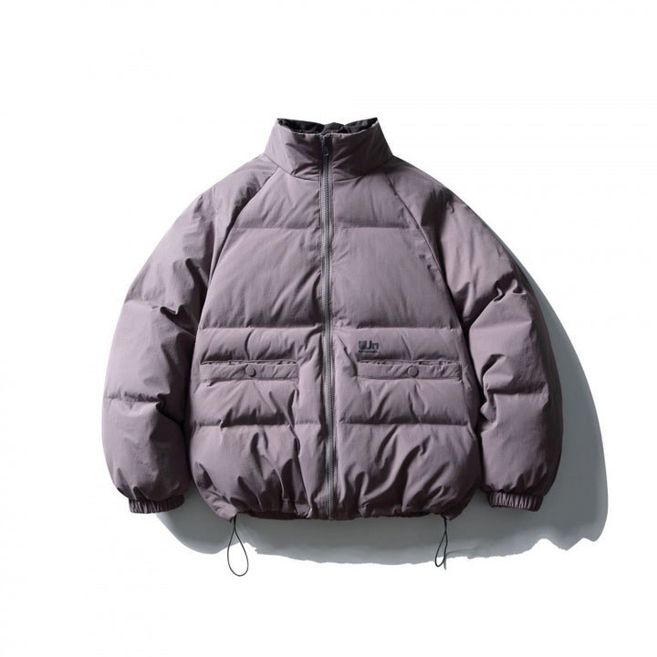 Unisex Boxy padded stand collar puffer jacket with drawstring hem and flap pockets Amarae