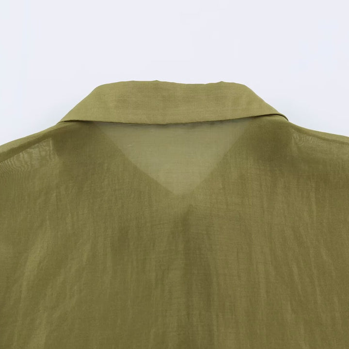 Women's silk effect blouse with voluminous sleeves, layered ruffles, and smocked cuffs