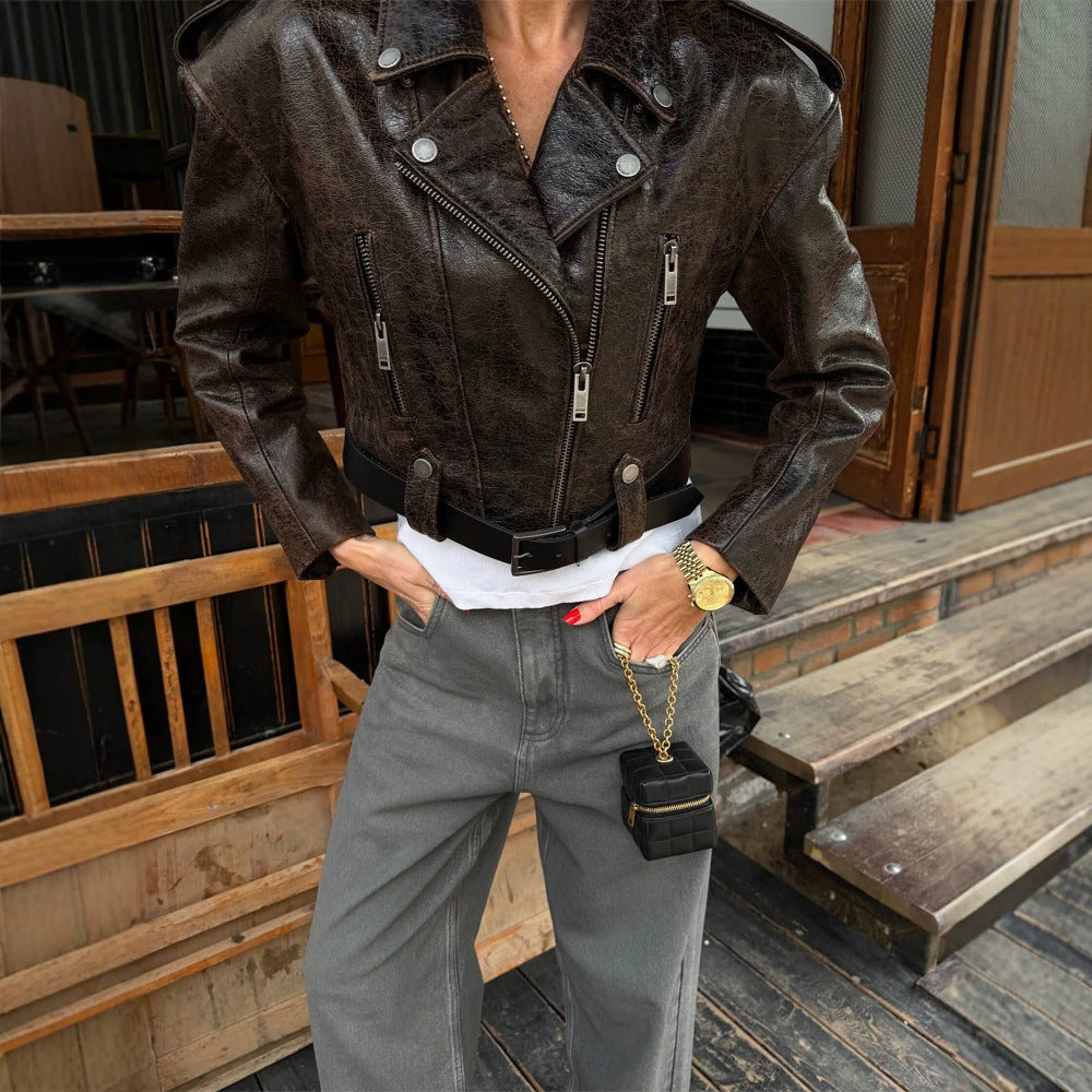 Women short cut biker jacket made of textured faux leather with waist belt Amarae