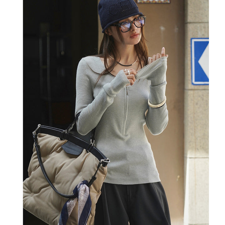Women's fitted ribbed top with visible zipper at the back