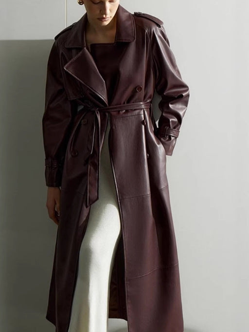 Elegant trench coat in faux leather for women with belt and chic fashion details