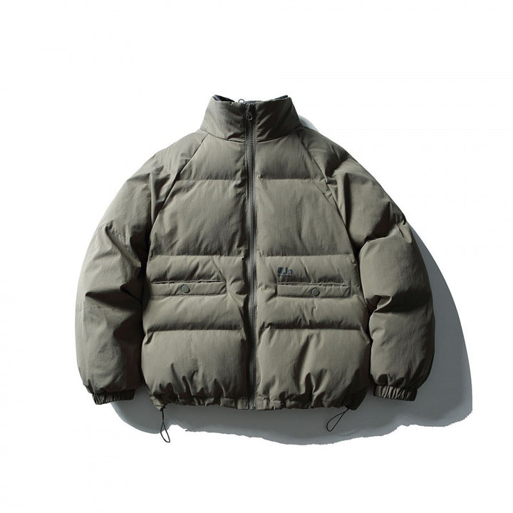 Unisex Boxy padded stand collar puffer jacket with drawstring hem and flap pockets Amarae