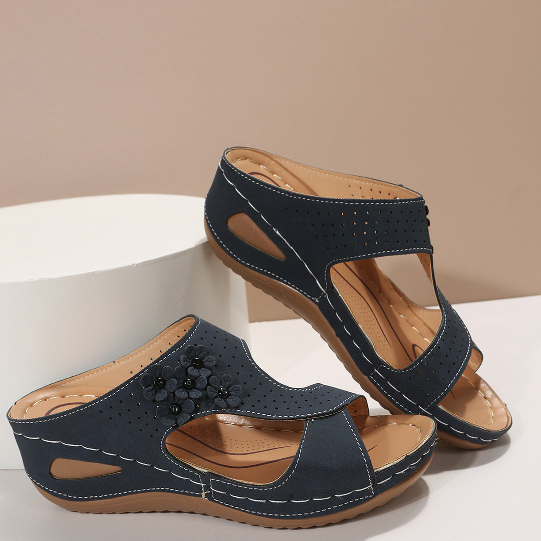 Comfortable wedge sole sandals for women with an airy surface structure and elastic straps Lune London