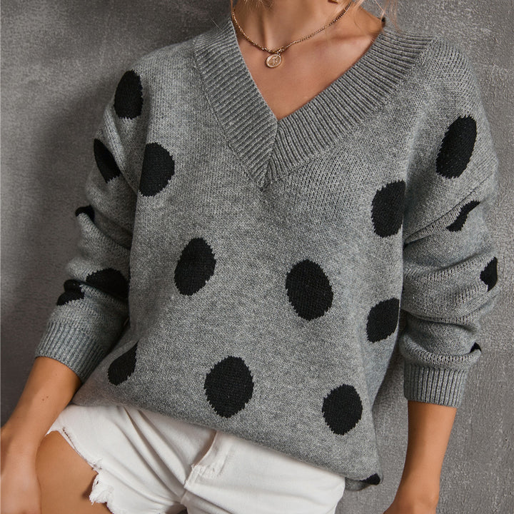 Pull féminin à la mode avec un décolleté en V profond et un design à pois graphiques Chic & Stil