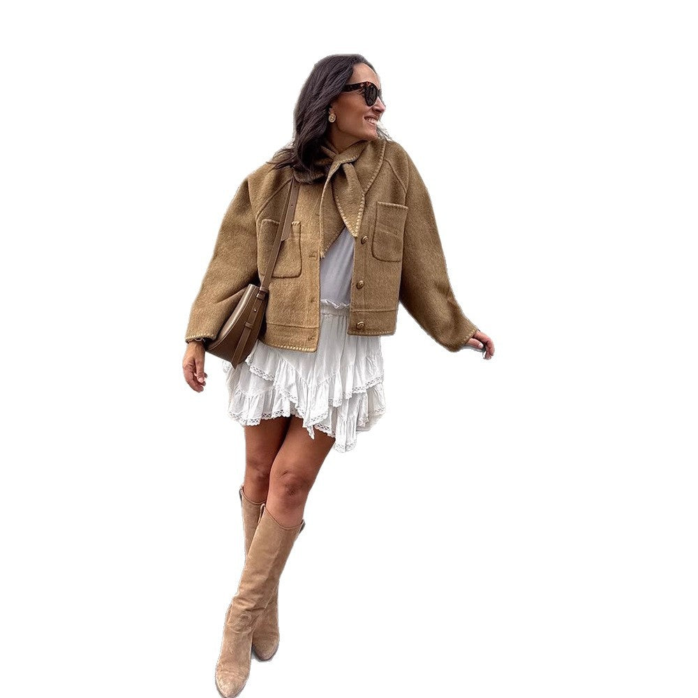 Women's short jacket made of wool blend with a suggested shawl collar, decorative seams, and boxy cropped cut Amarae