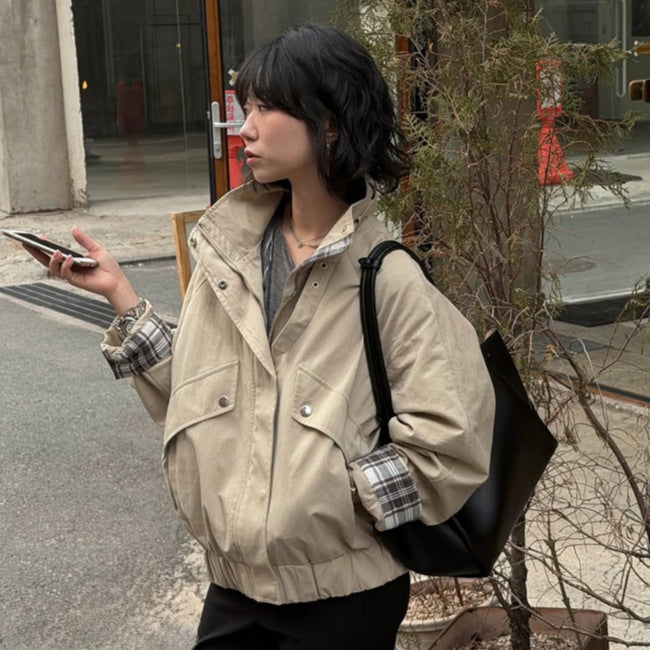 Women’s short bomber jacket with stand-up collar, chin strap, and checkered sleeve lining Amarae