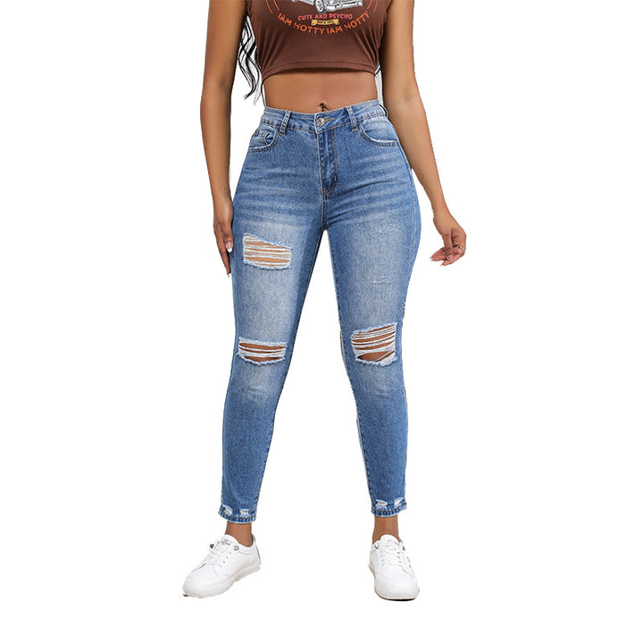 High-waisted women’s jeans with a trendy ripped look featuring strong tear details Lune London