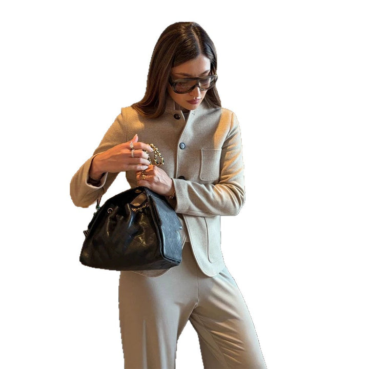 Women's tailored jacket blazer made of wool mix with stand-up collar, curved hem, and patch pockets.