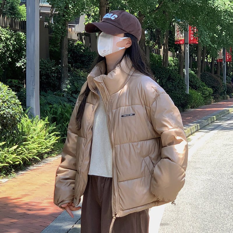 Trendy winter jacket for women with a high collar and zippered side pockets.